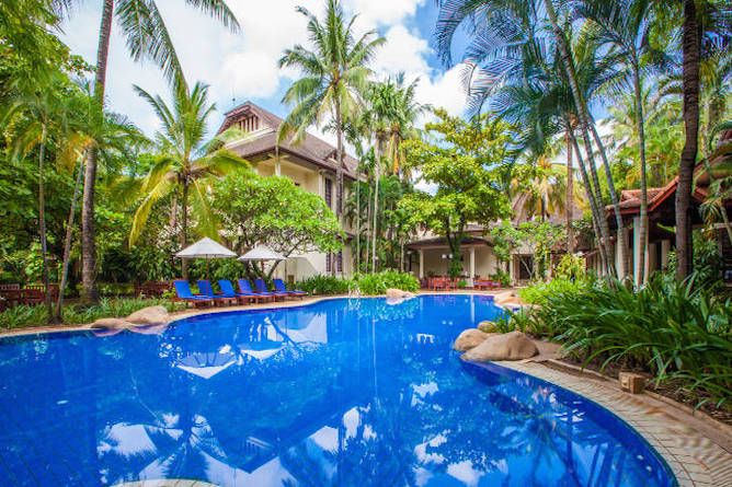 The pool is in a magnificent setting flanked by tropical palms, coconut trees and native plants