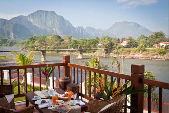 The Riverside suite private balcony with stunning views across the river and to the mountains beyond