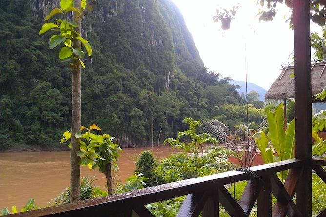 The private balcony affords spectacular views down the Nam Ou River