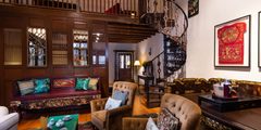 a room with a spiral staircase and chairs