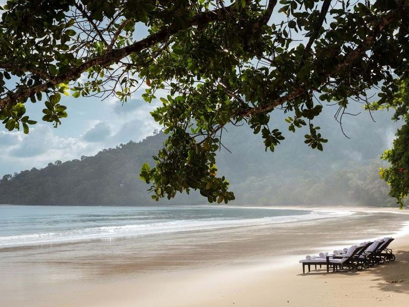 Beach with loungers at The Datai