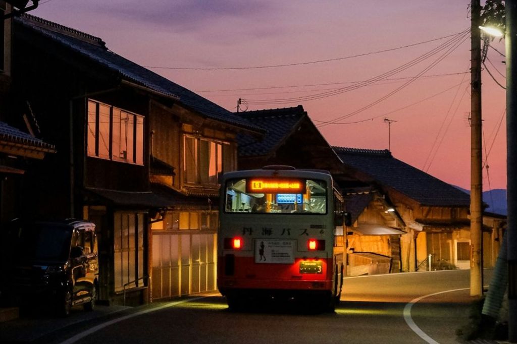 a bus driving down a street