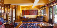 a room with a colorful rug and chairs