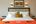 Double bedroom with bright orange design details