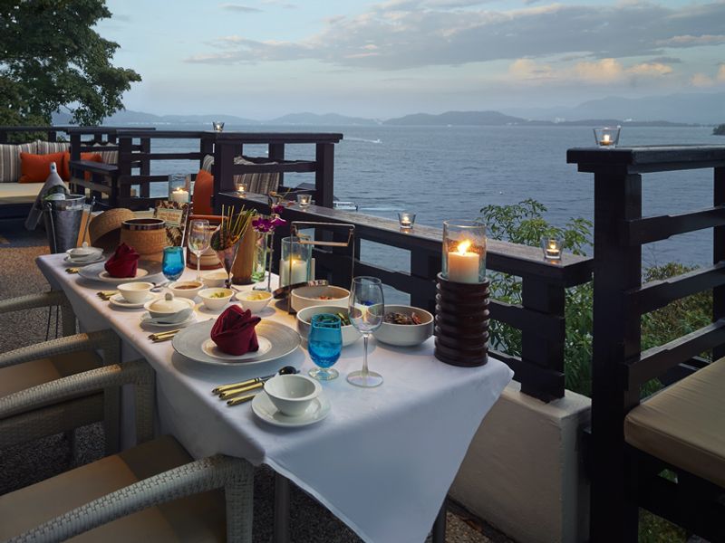 Table overlooking the sea at sunset at Gaya Island Resort
