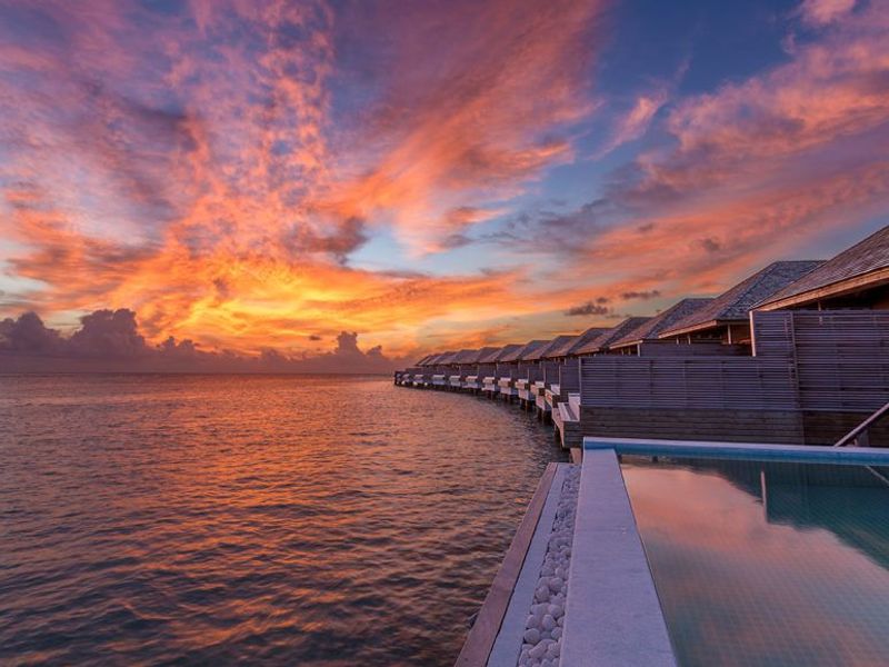 Sunset over villas at Hurawalhi