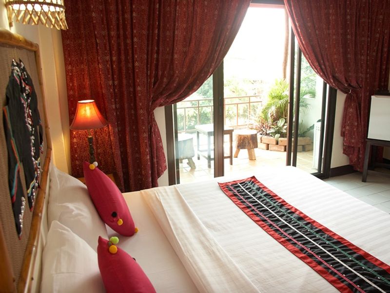 Red bedroom at Phumanee Lahu Home Hotel