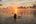 a person in a canoe at sunset