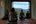 a group of people sitting in a room with a large window
