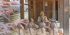 a group of statues of people sitting on the floor