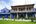 a blue building with a lawn and a red lantern