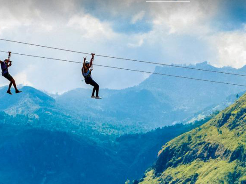 Two people ziplining