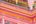 a pink building with gold railings