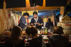 a group of people at a food stand