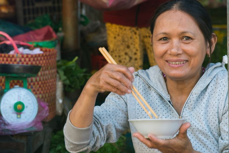 women sitting on the ground eating food