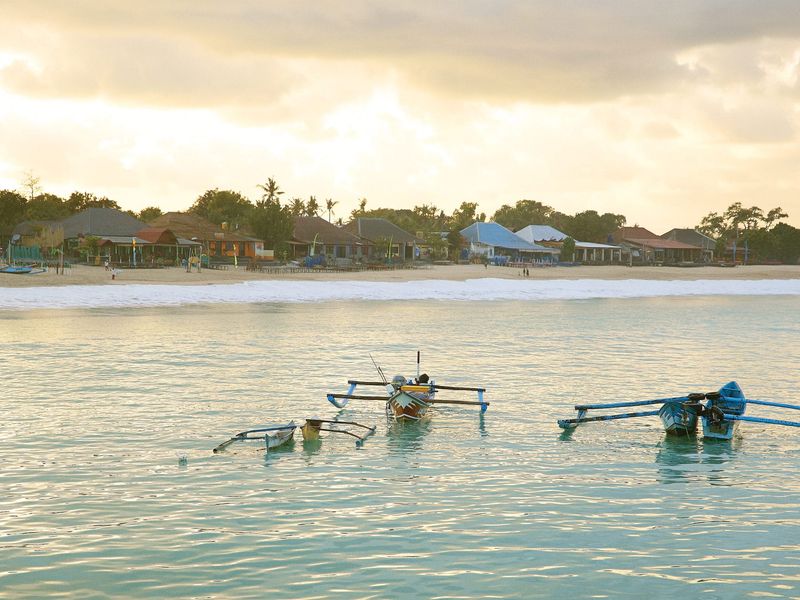 Fishing boats in the sea at sunset Belmond Jimbaran Puri Bali Indonesia