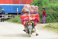 a man on a motorcycle carrying blankets