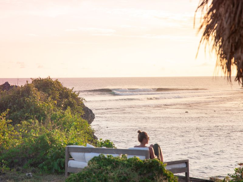 Woman watching sunset over the sea Nusa Tenggara Indonesia
