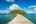 Wooden boardwalk over the sea leads to green jungle at Song Saa