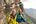 a man and woman posing for a picture with Paro Taktsang in the background