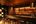 a bar with a shelf and stools