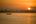 a boat in the water at sunset