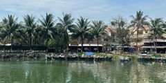 boats on the water next to a row of boats