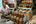 a man sitting in a store with jars of food