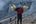 a person carrying baskets of corn on their shoulders
