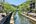 a river with trees and buildings in the background