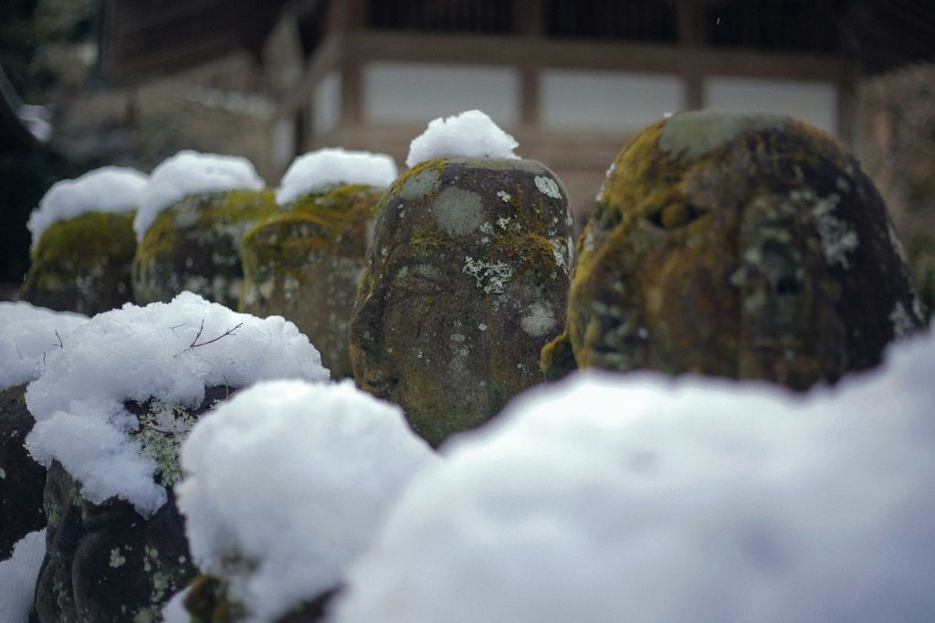a group of stone statues covered in snow