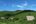 a house in the middle of a green hill