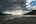 a beach with a cloudy sky