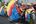 a group of people riding a bicycle with colorful decorations