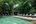 a pool with lounge chairs and a gazebo