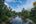a river with trees and a house