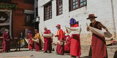 a group of people wearing red and orange robes