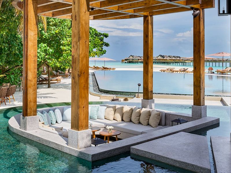 Seating by pool at Joali Maldives