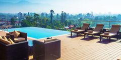 a deck with chairs and a pool