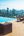 a deck with chairs and a pool