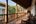 a long porch with benches and a wood railing