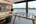 a room with a glass table and a couch and a picture of a man