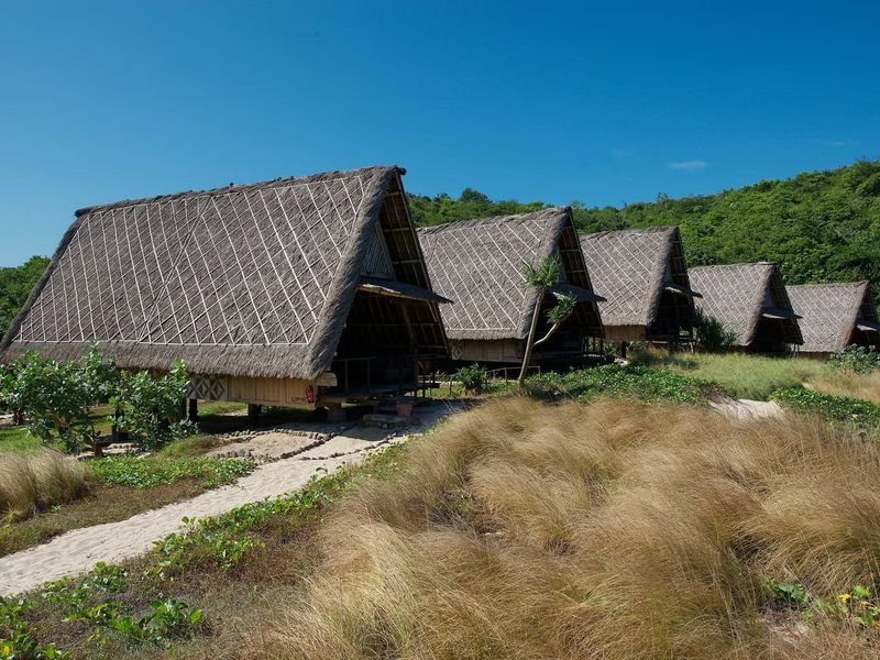 Thatched bungalows at Jeeva Beloam Beach Camp Lombok Indonesia