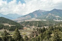 a landscape of a valley with trees and mountains
