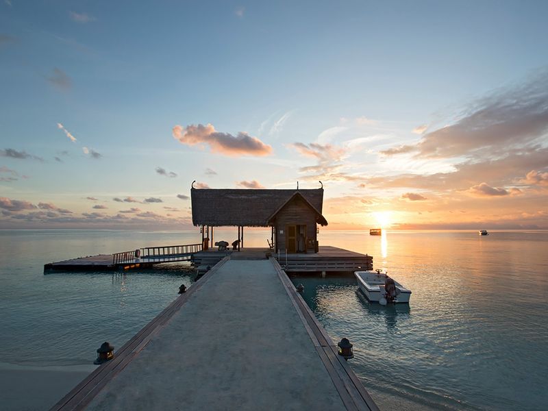 Jetty at sunset at Constance Moofushi