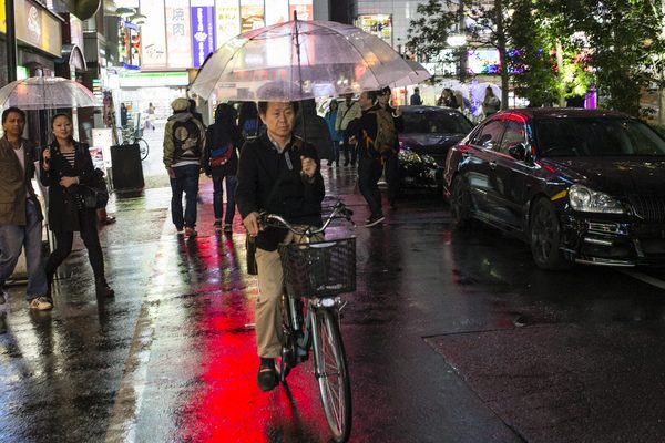 Man on bike in Japan city lights