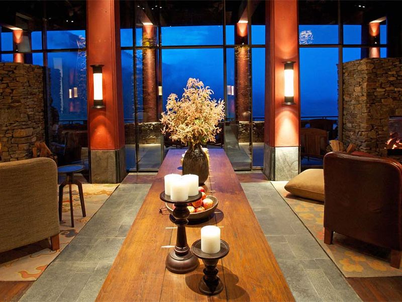 Armchairs by the fire at Gangtey Lodge