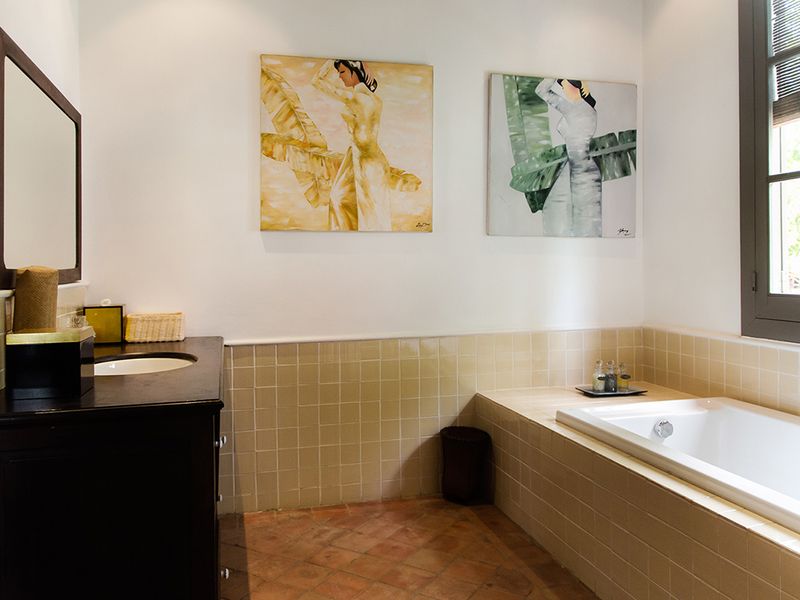 Bathroom with art at Satri House