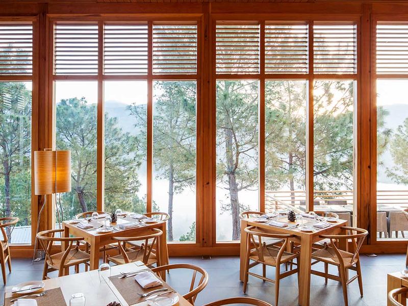 Restaurant with large picture windows at Dhensa Boutique Resort