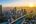 a rooftop view of a city with a sunset